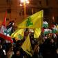 Lebanese sympathizers of the Shiite Hezbollah party wave Lebanese national and party (yellow) flags, as they march in a southern suburb of the capital Beirut