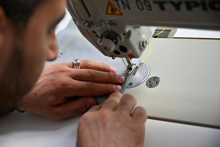 Syrian tailor Khaldoun Alhussain makes bags out of rubber boats used by refugees to reach Greek islands, for the Berlin-based company mimycri