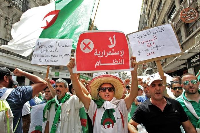 Algerian protesters on Friday braved a large police presence and called for civil disobedience for the first time since they began taking to the streets nearly six months ago