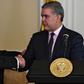 Colombian President Ivan Duque (R) shakes hands with Colombian Foreign Minister Carlos Holmes Trujillo during the signing of a decree that allows the nationalization of 24,000 children of Venezuelan parents born in Colombia August 5, 2019
