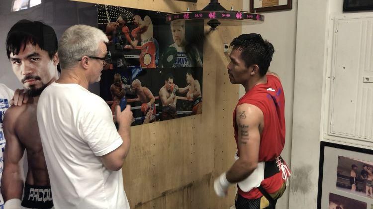 Pacquiao working the speed bag under the eye of coach Freddie Roach.