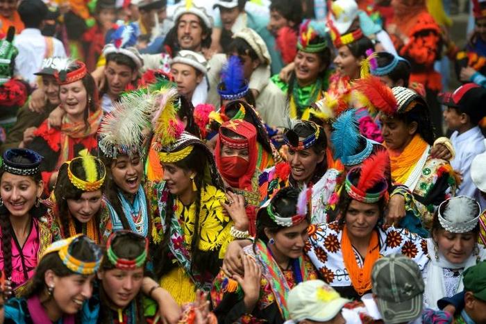In a remote valley in Pakistan dozens of Kalash minority women dance to celebrate spring's arrival -- but as a gaggle of men scramble to catch them on camera, the community warns an influx of domestic tourists is threatening their unique traditions
