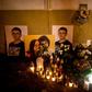 A picture taken in Bratislava on February 20, 2019 shows candles beside portraits of Slovakian journalist Jan Kuciak and his fiancee Martina Kusnirova who were found shot dead at the couple's home near Bratislava