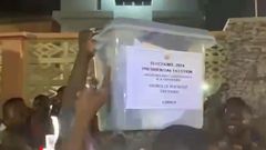 Angry crowd assaults police officer for trying to smuggle unsealed ballot boxes.