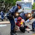 Police fired water guns and stun grenades to disperse the asylum-seekers staging a sit-in protest in the UN's Cape Town office