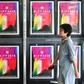 A woman walks past posters for the Busan International Film Festival at the Busan Cinema Center in South Korea