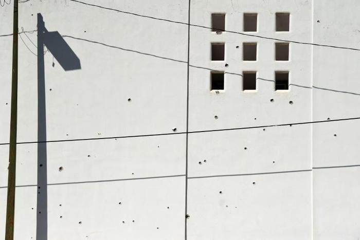 A wall riddled with bullet holes is seen after heavily armed gunmen waged an all-out battle against Mexican security forces in Culiacan