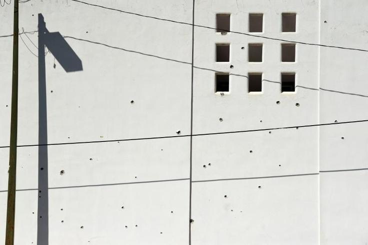 A wall riddled with bullet holes is seen after heavily armed gunmen waged an all-out battle against Mexican security forces in Culiacan