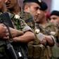 Lebanese soldiers wear white roses handed to them by protesters after they ignored pressure from the political establishment to reopen blocked roads, by force if necessary