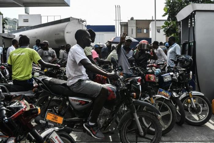 Motorcycle riders in Port-au-Prince, Haiti, wait in line to buy gasoline which is in increasingly short supply