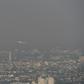 A commercial plane flies over smog-covered Chiang Mai on Tuesday