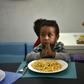 A child prays before eating at the Kapuy Foundation shelter which supports children abandoned, or with serious health problems, including undernourishment in Venezuela