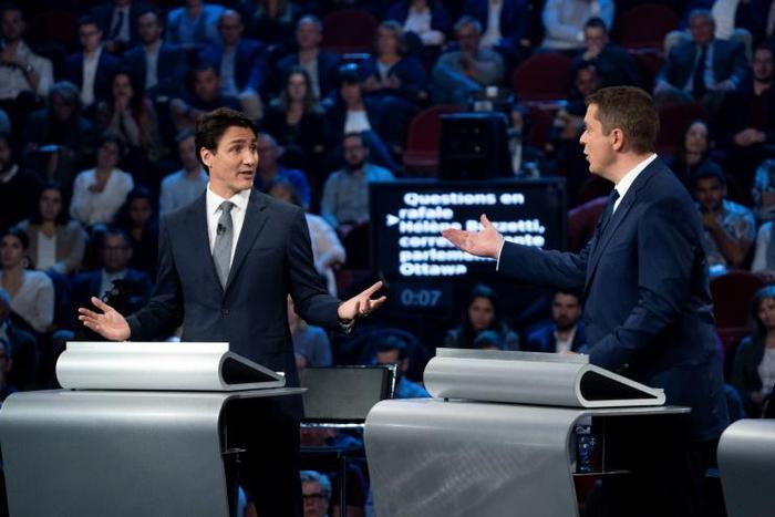 Canada's Prime Minister and Liberal leader Justin Trudeau (L) and Conservative leader Andrew Scheer, pictured here during a debat October 10, are in a dead heat on the eve of Canada's elections