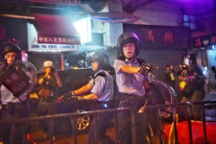 The rare move to ban the protest comes after officers drew their weapons to warn off radical protesters on Sunday night