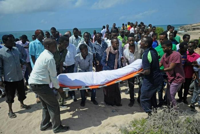 Relatives and fellow journalists pray as they stand next to the body of journalist Abdulaziz Ali Haji during his 2016 funeral in Somalia, described by a watchdog group as the worst country for enabling impunity for deadly attacks on media