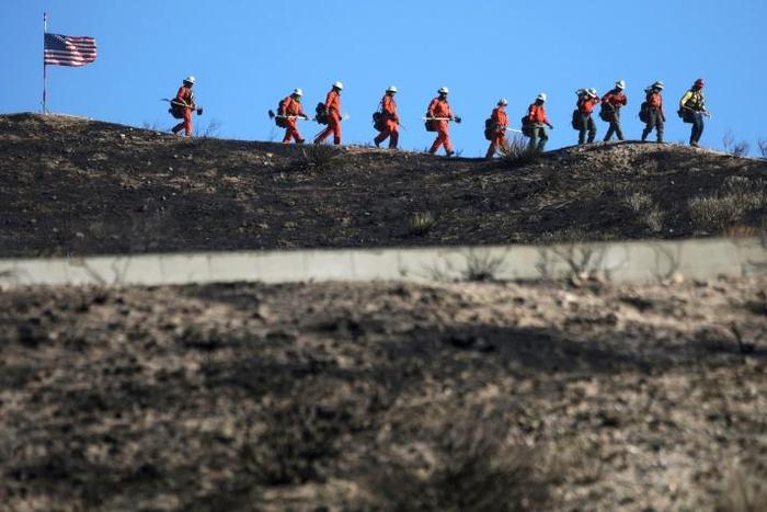 Tens of thousands of residents in southern California fled their homes as the so-called Tick Fire scorched over 4,000 acres (1,618 hectares)