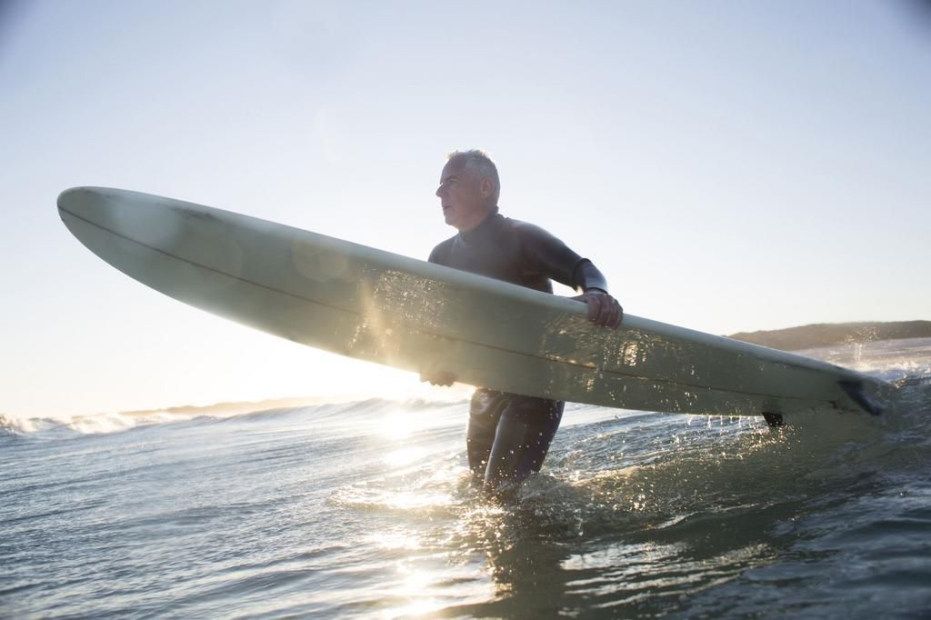 Senior man surfing