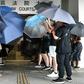Protesters covered themselves with umbrellas as they gathered outside the Eastern District Courts in Hong Kong