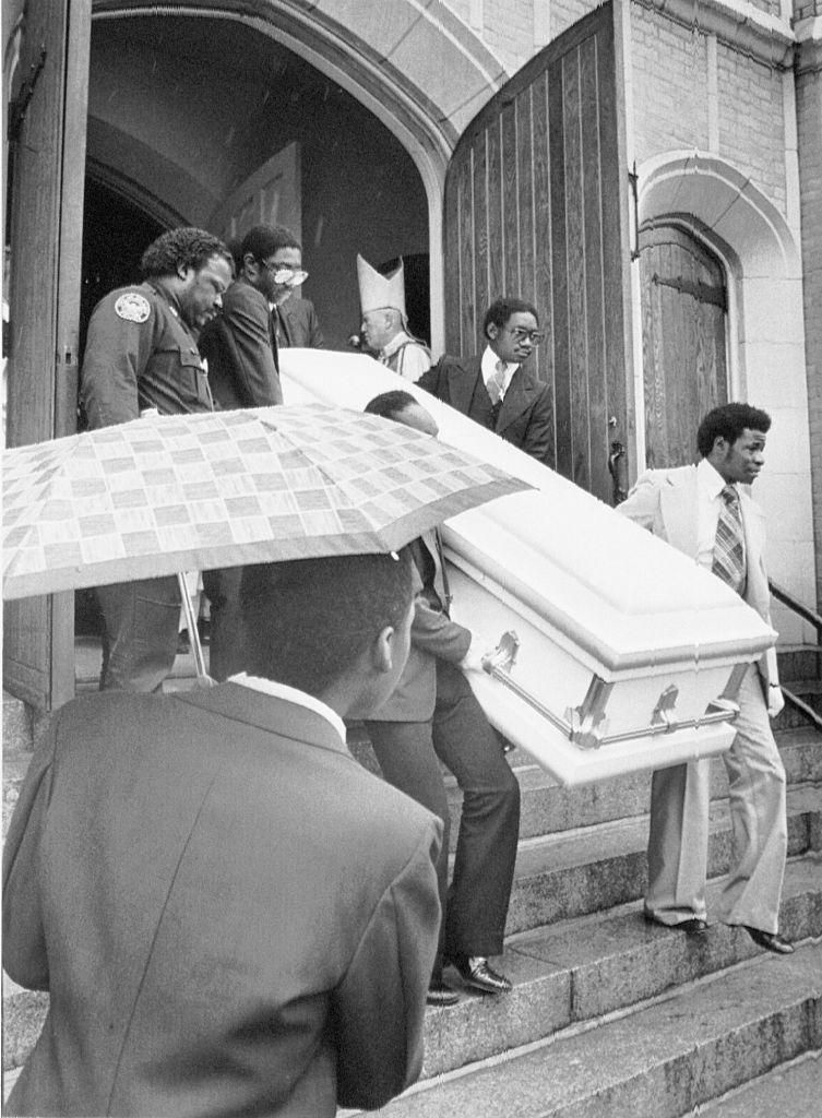 Patrick Balthazars body is carried down the steps of St. Anthonys church during his funeral service.