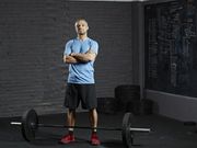 Portrait of smiling gym with barbell