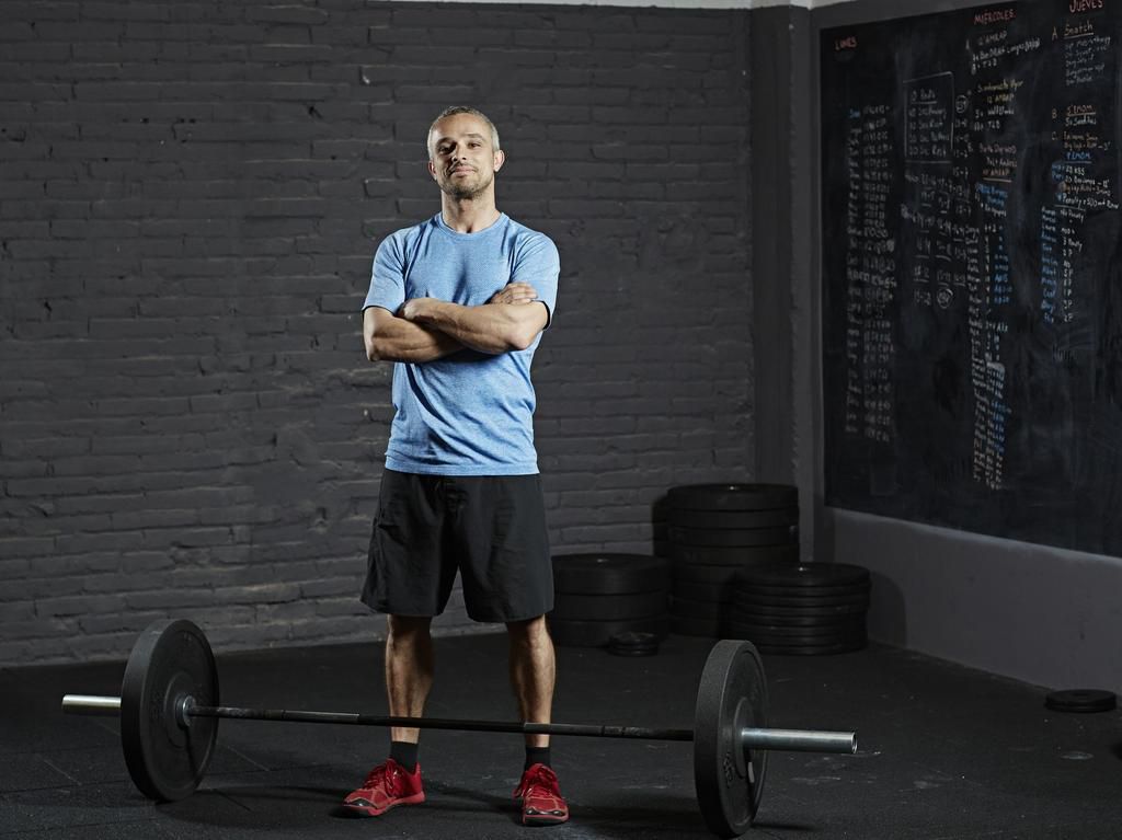 Portrait of smiling gym with barbell