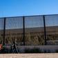 A family from El Salvador is pictured walking to turn themselves into Border Patrol agents after crossing the Rio Grande to claim asylum in El Paso, Texas