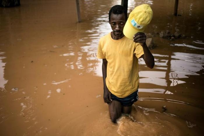 Fisherman Edouard walks among the flooded ruins of his house in Bangui. "I don't have the money to rebuild it," he said