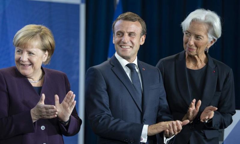 New ECB head Christine Lagarde (right) wants Germany Chancellor Angela Merkel (left) to increase public spending to give the sluggish European economy a boost, a move supported by French President Emmanuel Macon (centre)