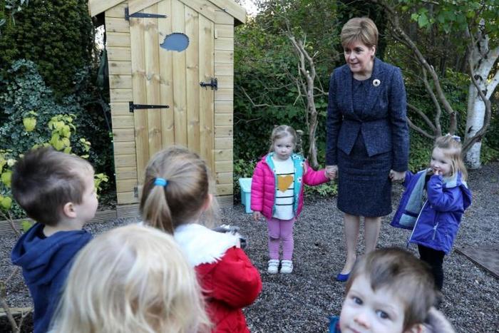 Scottish lawmakers have voted to ban parents and carers from smacking children; Scotland's First Minister Nicola Sturgeon holds hands with Evie Mackie (C) and Ella Bateman (R) on October 2, 2019