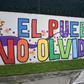 A woman walks by a mural painted outside the headquarters of the UN International Commission Against Impunity (CICIG)