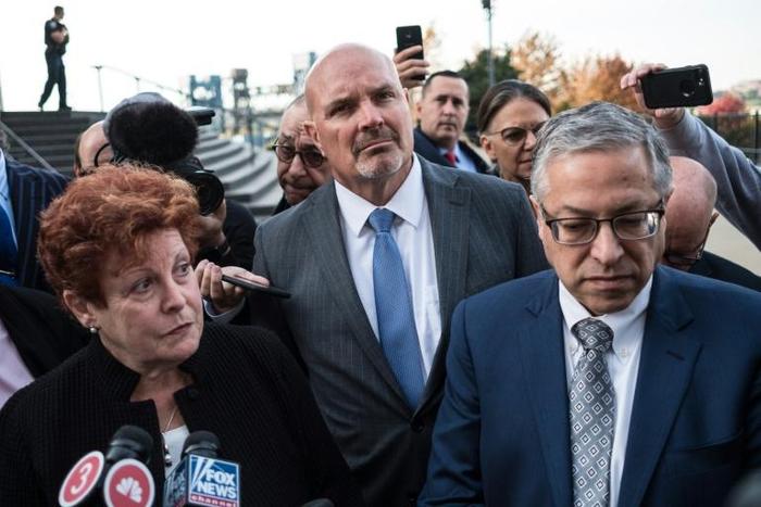 Ilene Shapiro (left), executive director of Summit County, Michael O'Malley (center), the Cuyahoga county prosecutor, and Mark Lanier, a lawyer representing Cuyahoga and Summit counties, brief the press in Cleveland, Ohio