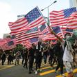 Many of those marching waved American flags