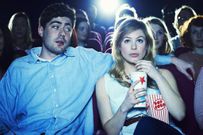 couple enjoying a movie at the cinema