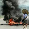 A supporter of Bolivian opposition candidate Carlos Mesa passes a burning barricade during clashes with supporters of Bolivian President Evo Morales on October 24, 2019