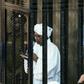 Sudan's ex-president Omar al-Bashir (C) appears in court in the capital Khartoum to face charges of illegal acquisition and use of foreign funds