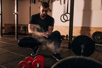 Muscular guy on cross training - weightlifting and squats