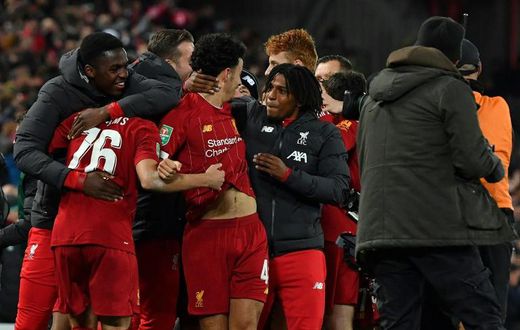 Liverpool players celebrate their penalty shootout victory over Arsenal to reach the League Cup quarter-finals
