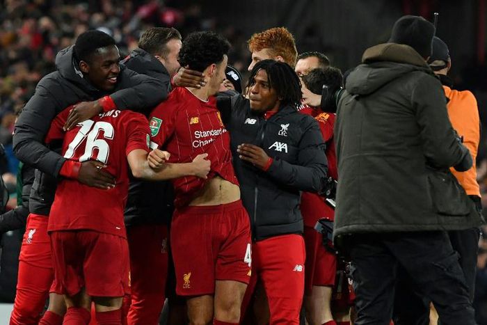 Liverpool players celebrate their penalty shootout victory over Arsenal to reach the League Cup quarter-finals