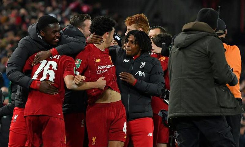Liverpool players celebrate their penalty shootout victory over Arsenal to reach the League Cup quarter-finals