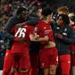 Liverpool players celebrate their penalty shootout victory over Arsenal to reach the League Cup quarter-finals