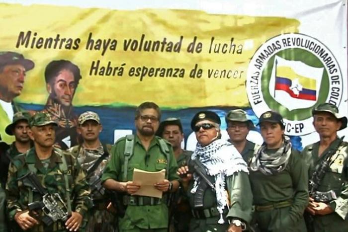 Former senior commander Ivan Marquez (center) and fugitive rebel colleague Jesus Santrich (in sunglasses), of the dissolved FARC rebel army group in Colombia, announced that they are taking up arms again along with other guerrillas