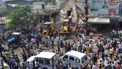 Earth movers clear debris at the site of the explosion in Petlawad, Madhya Pradesh state.