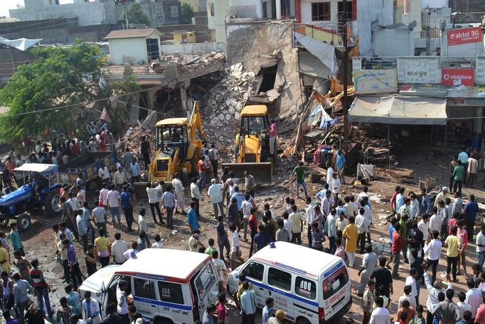 Earth movers clear debris at the site of the explosion in Petlawad, Madhya Pradesh state.
