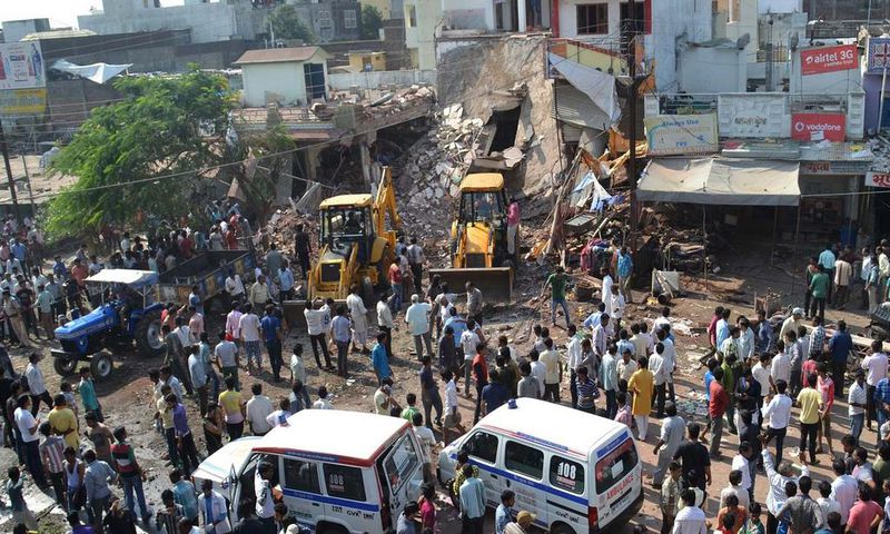 Earth movers clear debris at the site of the explosion in Petlawad, Madhya Pradesh state.