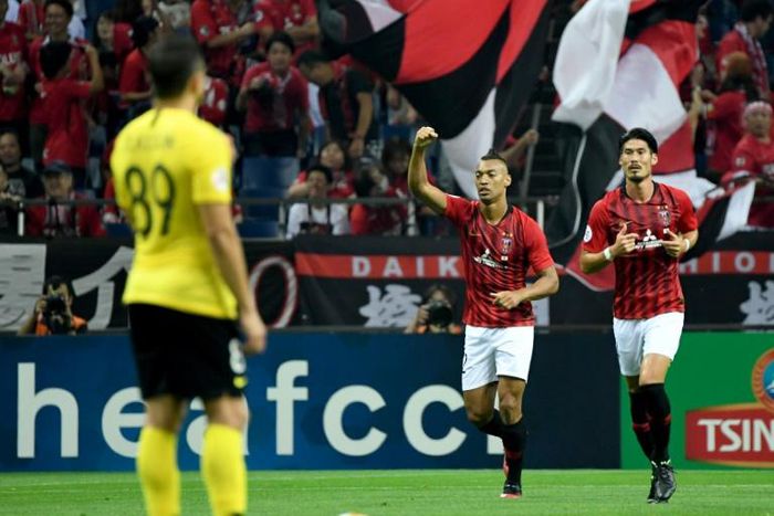 Urawa's midfielder Fabricio raises his arm to celebrate his first-half goal against Guangzhou Evergrande during the AFC Champions League semi-final first leg in Saitama