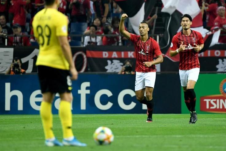 Urawa's midfielder Fabricio raises his arm to celebrate his first-half goal against Guangzhou Evergrande during the AFC Champions League semi-final first leg in Saitama