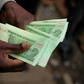 Electronic money and "bond" notes -- a legal tender pegged to the US dollar -- were introduced to ease cash shortages