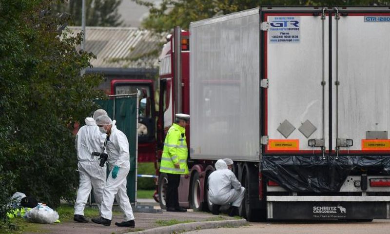 British Police forensics officers work on lorry, found to be containing 39 dead bodies, at Waterglade Industrial Park in Grays, east of LondonindusTrial park in Grays, east of London