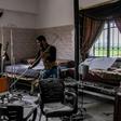 A Syrian man clears rubble in a hospital that was hit by an alleged regime air strike in the town of Saraqib, northern Idlib province, on March 10, 2019
