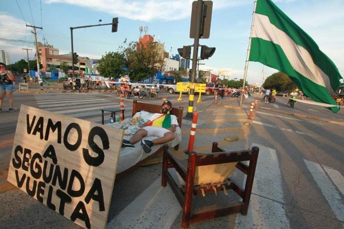 A supporter of Bolivian opposition candidate Carlos Mesa blocks an avenue in Santa Cruz